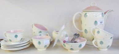 Susie Cooper coffee set, of cream ground decorated with green foliate leaves with pink glaze inside,