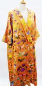 A mid 19th century orange satin embroidered coat, lavishly embroidered with butterflies, flowers,