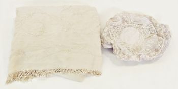 Lace bonnet and a piece of oriental silk embroidery in cream