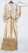A 1930's gold lame dress and matching jacket, the dress bias cut, the jacket peplum and gilt