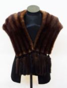 A mink jacket with the tails braided as a trim