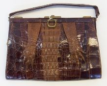Crocodile handbag, showing the feet and back on back the bag, fixed frame with brass fittings