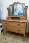 Early twentieth century dressing chest, with shaped bevelled edged swing mirror to top, supported