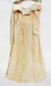 A late 19th century cream silk dress, pleated skirt, a pleated off the shoulkder neckline, the