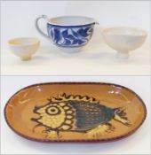 Two studio ware white bowls, blue and white pottery jug and a pottery dish, decorated with fish (4)
