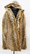 A faux fur cape, printed as leopard skin with a hood