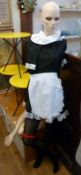 Shop window mannequin, (her one hand missing), wearing a French maid's costume
