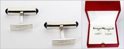 Pair Cartier silver, cream lacquer and black onyx gentleman's cufflinks, each of baton form, with