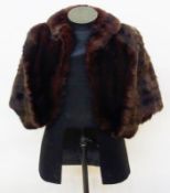 A dark mink short cape with shawl collar