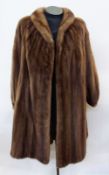 An Italian full length mink coat with puffed sleeves, stand up collar