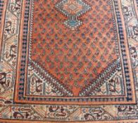 Small eastern wool rug with hooked lozenge medallion on a ground of botehs, ivory borders