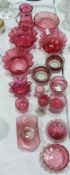 Large collection of cranberry glass, including three frilled edged bowls, various small salts, pin