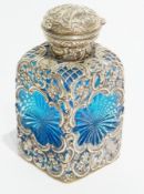 A late Victorian silver and blue glass square cut scent bottle with hinged cover, with C-scroll