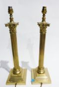 Pair brass table lamps, each in the form of Corinthian column and two cream and gold lampshades