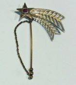 Silver gilt stickpin with red stone star and feather pattern