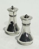 A pair of silver capstan shaped salt and pepper pots, London 1917, height 8cms