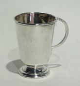Silver tankard of tapering cylindrical form raised on circular foot, Sheffield 1945, height 11cms,