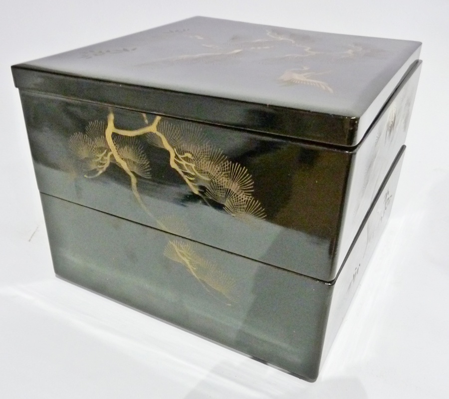 Pair of oriental lacquer stacking boxes, two levels with lid, decorated with gilt enamel showing