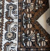 Small cream and brown pile rug of Eastern style