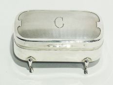 A rectangular silver jewellery box, with engine turned hinged cover, raised on pad feet, by Mappin