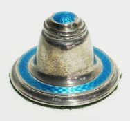 An Edwardian silver and blue enamel inkwell, with hinged cover and glass liner of spreading circular