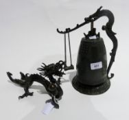 Bronzed metal model dragon, holding pearl, another dragon figure, and table bell with dragon
