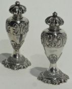 A pair of silver salt and pepper pots, with scroll work decoration, baluster shaped, Sheffield 1898,