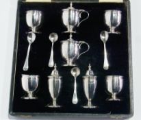 Three pairs silver condiments of plain form, raised on a circular foot, with spoons, in fitted case,