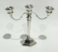 A silver twin branch candelabrum on an hexagonal tapering column and raised base, Birmingham 1971,