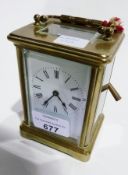 Brass carriage clock, with ribbed circular handle, on plinth base