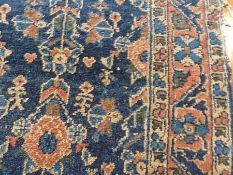 Antique Shiraz wool rug, the blue ground with three rows of stylised flowers, running flowerhead