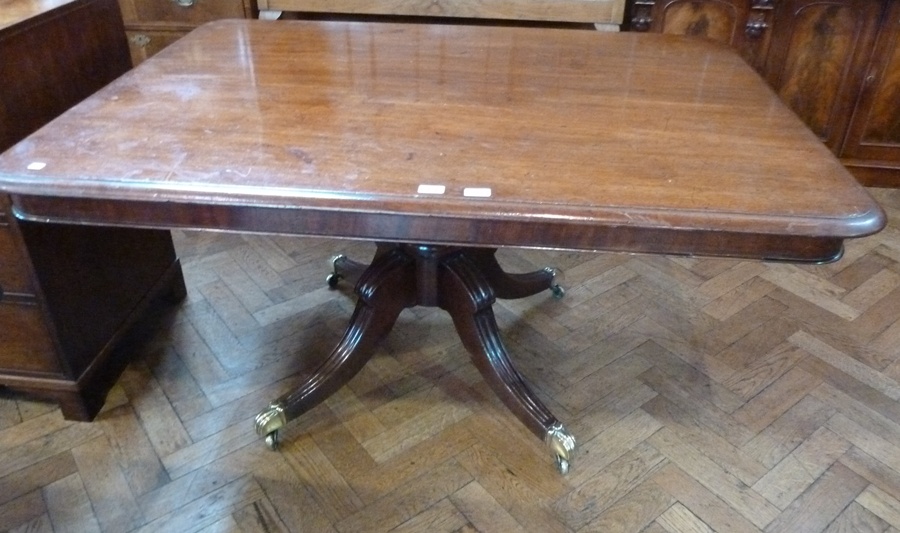 A Georgian mahogany rectangular top supper table with moulded edge, raised on turned column support,