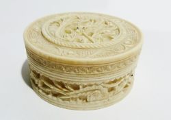 Chinese carved ivory pill box, showing a fantastical creature on the lid and around sides