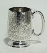 A small silver mug with foliate engraving 1912, raised on circular foot, hallmarked Birmingham 1910,