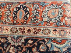 Pair Tabriz wool rugs, each with dark navy ground, allover palmette scrolling foliage decoration,