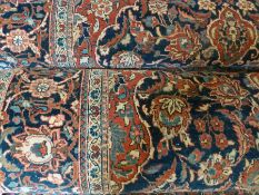 Pair Kashan wool rugs, each with blue ground, red central shaped lozenge medallion, allover floral