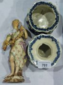 Meissen figure of a girl holding a garland and seated on a log, together with a pair of blue and