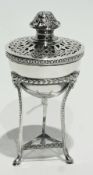 A George V silver pot pourri on stand with pierced open fretwork cover, raised on square tapering
