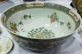 Chinese famille verte bowl, with gentleman on a flying crane in centre, with green border