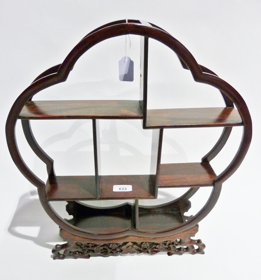 Oriental polished and carved wood display stand, circular and scalloped with row of small shells, on