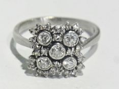 Platinum and diamond cluster ring, square-shaped set five collet set diamonds, all surrounding by