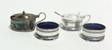 A silver condiment set comprising a pair of oval salts with blue glass liners and a matching mustard