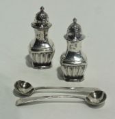 A pair of silver salt and pepper pots, London 1895, 8cms high, and a pair of Georgian silver mustard
