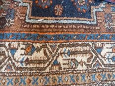 Eastern wool rug with stylised motifs, blue spandrels, ivory borders