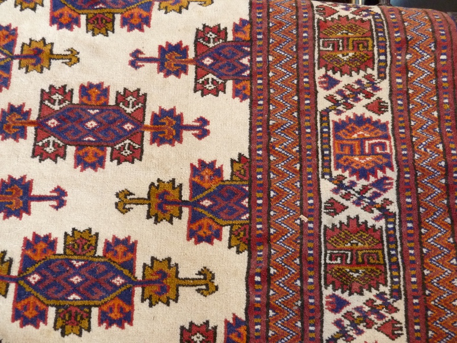 Modern Persian wool carpet, the cream ground with geometric lozenge medallions, stylised