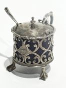 A Victorian silver lidded mustard pot, open fretwork design with blue glass liner raised on claw and