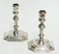 Pair eighteenth century style silver candlesticks, with baluster turned stems to a square