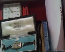 Three lady's wristwatches, lady's fob watch and an alarm clock