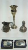 A silver flower vase, two decanter labels, cream jug and a scent bottle (5)