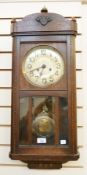 Twentieth century oak case wall clock, with turned finials, brass dial, large brass pendulum, with